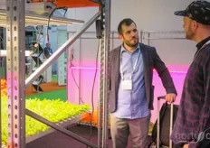 Matthias Droste (R) in conversation with a participant at HortiBest LED Grow Lights. 